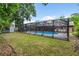 Spacious backyard with screened pool enclosure and well-maintained lawn at 313 Houston Dr, Ladson, SC 29456