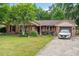 Charming brick home with lush lawn, blooming flowerbeds and a single car garage at 313 Houston Dr, Ladson, SC 29456
