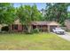 Charming brick home with lush lawn, blooming flowerbeds and a single car garage at 313 Houston Dr, Ladson, SC 29456