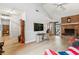 Open living room flows seamlessly, showcasing wood-look floors and a brick fireplace at 313 Houston Dr, Ladson, SC 29456