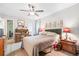 Spacious main bedroom featuring hardwood floors, neutral paint, a ceiling fan, and ample natural light at 313 Houston Dr, Ladson, SC 29456