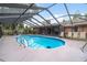 Sparkling swimming pool with screened enclosure and ample seating for outdoor entertaining at 313 Houston Dr, Ladson, SC 29456