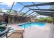 Sparkling swimming pool with screened enclosure and ample seating for outdoor entertaining at 313 Houston Dr, Ladson, SC 29456