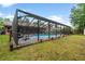 Sparkling swimming pool with screened enclosure and well-maintained lawn at 313 Houston Dr, Ladson, SC 29456