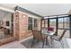 Enclosed sunroom with brick accent wall, tile flooring and bright natural light overlooking backyard at 313 Houston Dr, Ladson, SC 29456
