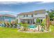 Spacious backyard with refreshing pool, outdoor lounge chairs, and tropical plants at 3173 Hugh Bennett Dr, Johns Island, SC 29455