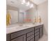 Bathroom featuring double sink vanity, large mirror, and neutral color palette at 3173 Hugh Bennett Dr, Johns Island, SC 29455