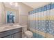 Cozy bathroom with a modern vanity, toilet, and colorful shower curtain, creating a functional space at 3173 Hugh Bennett Dr, Johns Island, SC 29455