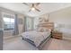 Bright bedroom featuring a wood accent headboard, soft carpet, and a cozy atmosphere with natural light at 3173 Hugh Bennett Dr, Johns Island, SC 29455
