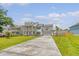 Charming two-story home with a well-maintained front lawn, a wide driveway, and a welcoming facade at 3173 Hugh Bennett Dr, Johns Island, SC 29455