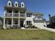 Charming two-story home with inviting front porch, manicured lawn, and attached two car garage at 3173 Hugh Bennett Dr, Johns Island, SC 29455