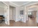 Hallway with stylish decor, white walls, leading to an office and living area, creating a seamless flow at 3173 Hugh Bennett Dr, Johns Island, SC 29455