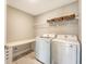 Well-equipped laundry room features modern washer, dryer, and storage shelves at 3173 Hugh Bennett Dr, Johns Island, SC 29455