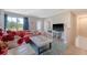 Well-lit living room with backyard views, a red sofa, a modern TV, and seamless access to the outdoors at 3173 Hugh Bennett Dr, Johns Island, SC 29455