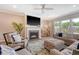 Comfortable living room highlighting a fireplace, sectional sofa, and bright windows at 3173 Hugh Bennett Dr, Johns Island, SC 29455