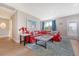 Bright and inviting living room with a cozy red sofa, a stylish rug, and easy access to the outdoors at 3173 Hugh Bennett Dr, Johns Island, SC 29455