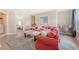 Comfortable living area with a red sofa, soft rug, and cozy decor, creating a welcoming atmosphere at 3173 Hugh Bennett Dr, Johns Island, SC 29455
