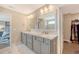 Well-lit main bathroom boasts dual sinks, vanity, and separate access to the closet at 3173 Hugh Bennett Dr, Johns Island, SC 29455