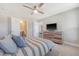 Comfortable main bedroom boasts ceiling fan, TV, and ensuite bathroom at 3173 Hugh Bennett Dr, Johns Island, SC 29455