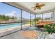 Screened patio offers views of the pool, lush landscaping, and outdoor seating area at 3173 Hugh Bennett Dr, Johns Island, SC 29455