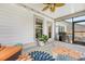 Relaxing screened patio with outdoor seating, ceiling fan, and stylish rug at 3173 Hugh Bennett Dr, Johns Island, SC 29455