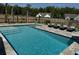 Sparkling blue swimming pool with lounge chairs and lush landscaping in a private backyard setting at 3173 Hugh Bennett Dr, Johns Island, SC 29455