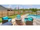 Inviting pool area with comfortable seating around a fire pit, perfect for enjoying evenings outdoors at 3173 Hugh Bennett Dr, Johns Island, SC 29455