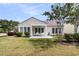 Home's backyard offers a spacious patio with chairs, a lush lawn, and abundant natural light at 318 Oyster Bay Dr, Summerville, SC 29486
