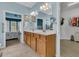 Bathroom with double vanity, framed mirrors, and walk-in closet for luxurious living and storage at 318 Oyster Bay Dr, Summerville, SC 29486