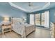 Serene primary bedroom with tray ceiling, calming blue walls, and natural light streaming through large windows at 318 Oyster Bay Dr, Summerville, SC 29486