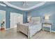 Stylish primary bedroom boasts a decorative tray ceiling, hardwood floors, and an ensuite bathroom at 318 Oyster Bay Dr, Summerville, SC 29486