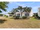 Exterior view showcasing a well-manicured lawn and a charming patio with beautiful trees at 318 Oyster Bay Dr, Summerville, SC 29486
