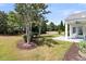 Inviting front yard with mature trees and landscaping leading to a charming covered porch area at 318 Oyster Bay Dr, Summerville, SC 29486