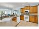 Spacious kitchen featuring tile floors, wooden cabinets, and modern appliances under a chandelier-lit ceiling at 318 Oyster Bay Dr, Summerville, SC 29486