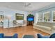 Inviting living room boasts hardwood floors, ceiling fan, and large windows for ample natural light at 318 Oyster Bay Dr, Summerville, SC 29486