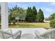 Covered patio features a sitting area and tranquil view of the manicured front yard at 318 Oyster Bay Dr, Summerville, SC 29486