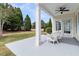 Inviting porch with white wicker furniture and a view of the landscaped front yard at 318 Oyster Bay Dr, Summerville, SC 29486