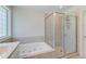 Bright bathroom featuring a soaking tub and a glass-enclosed shower at 321 Bounty Ln, Charleston, SC 29412