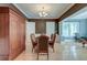 Elegant dining room with hardwood floors, chandelier, table with chairs, and white trim at 321 Bounty Ln, Charleston, SC 29412