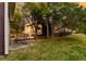 Charming home exterior with a lush lawn and a quaint patio area visible beneath mature trees at 321 Bounty Ln, Charleston, SC 29412