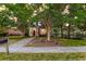 Charming two-story home featuring mature trees, front porch, and landscaped yard at 321 Bounty Ln, Charleston, SC 29412