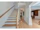 Bright foyer featuring hardwood floors, elegant staircase, and classic architectural details at 321 Bounty Ln, Charleston, SC 29412