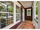 Cozy porch space with white trim and a brick floor, offering a charming spot for relaxation at 321 Bounty Ln, Charleston, SC 29412