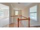 Bright hallway with wood floors, a window with blinds and a staircase with wooden handrails at 321 Bounty Ln, Charleston, SC 29412