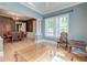Spacious living room with hardwood floors, blue accent wall, and large windows for natural light at 321 Bounty Ln, Charleston, SC 29412