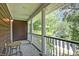 Charming porch with decorative columns, seating, and a view of the street and trees at 321 Bounty Ln, Charleston, SC 29412