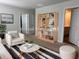 Bright living room boasts stylish decor and an open layout to the hallway and other rooms at 323 Bear Paw Ln, Summerville, SC 29486