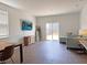Bright living room with wood flooring, a comfortable sofa, and a sliding door to the backyard at 323 Bear Paw Ln, Summerville, SC 29486