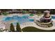 Community pool with water slide, sundeck, lounge chairs, umbrellas, and lush landscaping at 323 Bear Paw Ln, Summerville, SC 29486