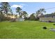 Large backyard featuring green grass, a storage shed, and plenty of open space at 33 Elliott Ct, Walterboro, SC 29488